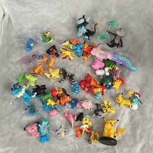 Colorful Pokémon Figurine Collection with a tin box.